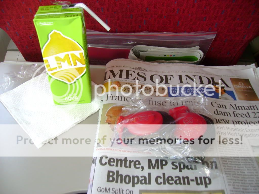 Welcome - lemon drink, headsets and newspaper